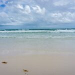 blue sea under blue sky and white clouds during daytime