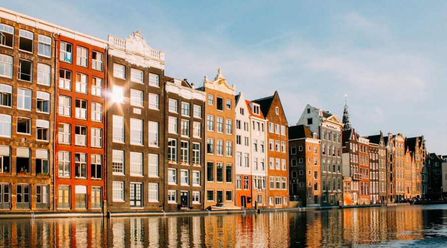 assorted-color buildings beside body of water